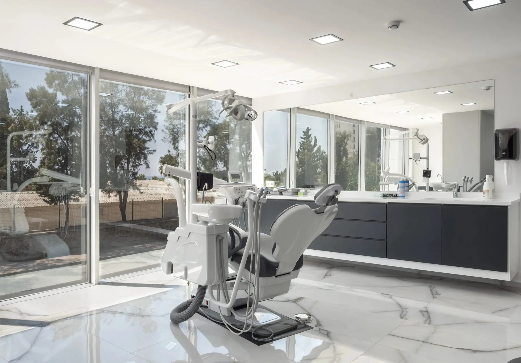 A treatment suite at the clinic in Antalya, with the dental chair facing floor-to-ceiling windows