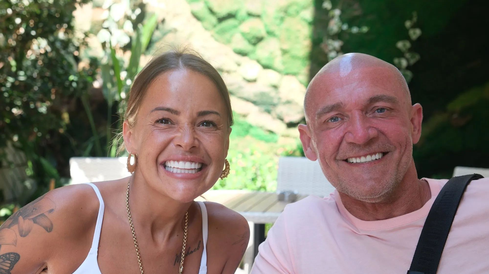 Two UK Smiles patients showing their new smiles in a hotel garden in Antalya