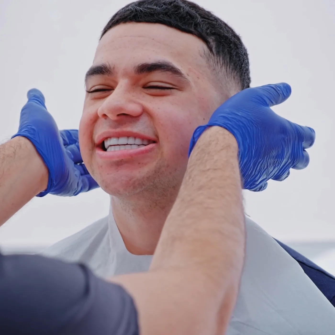 UK Smiles patient smiling as the dentist checks his new smile