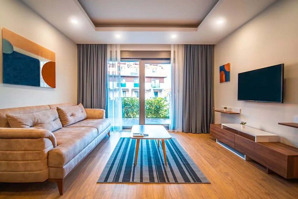 Living room of a hotel apartment in Antalya with a sofa and TV