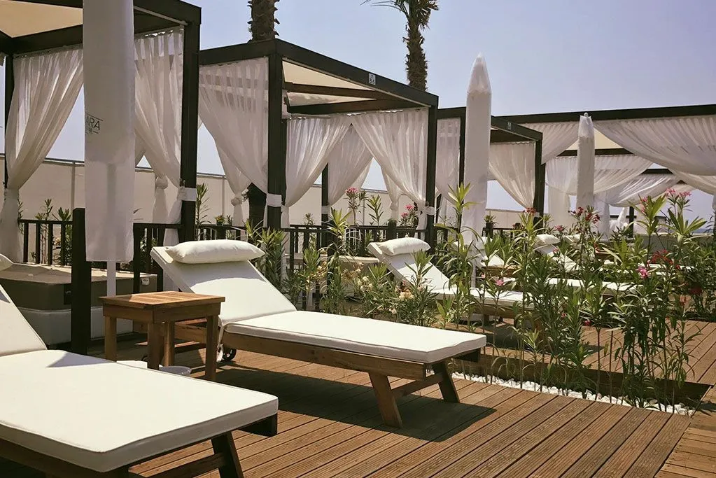 Shaded cabanas and sun loungers on the hotel terrace in Lara