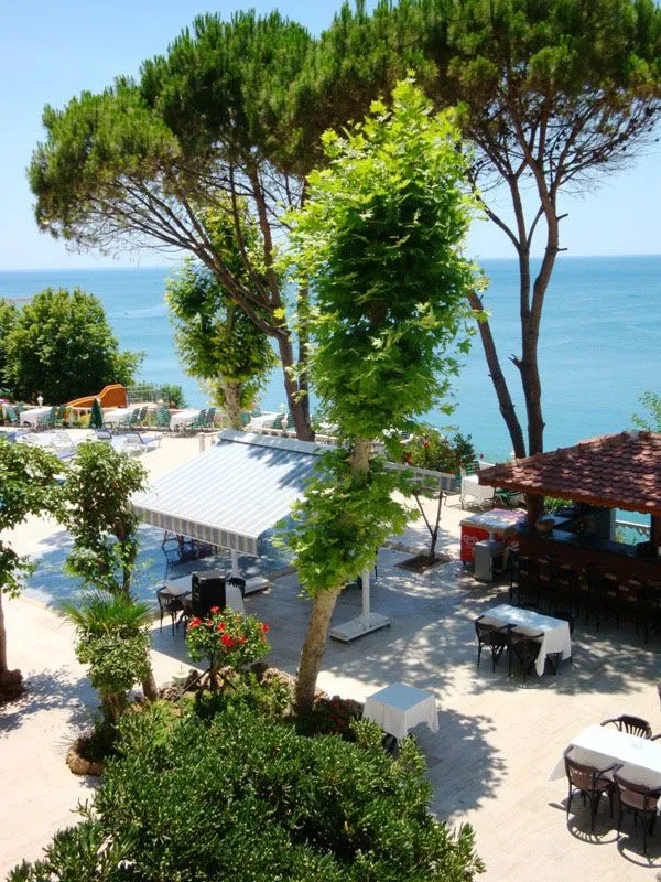 Hotel garden and restaurant terrace with a sea view in Lara, Antalya