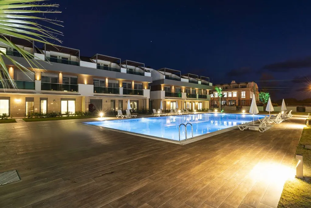 Hotel pool lit up at night in Lara, Antalya