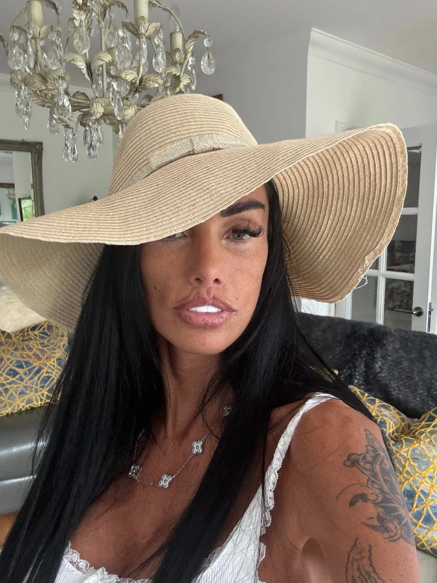 Katie Price in a wide-brimmed straw hat, showing her current look