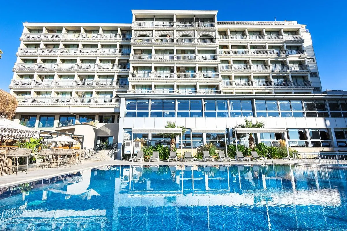 Front of a Lara Beach hotel with its outdoor pool in Antalya