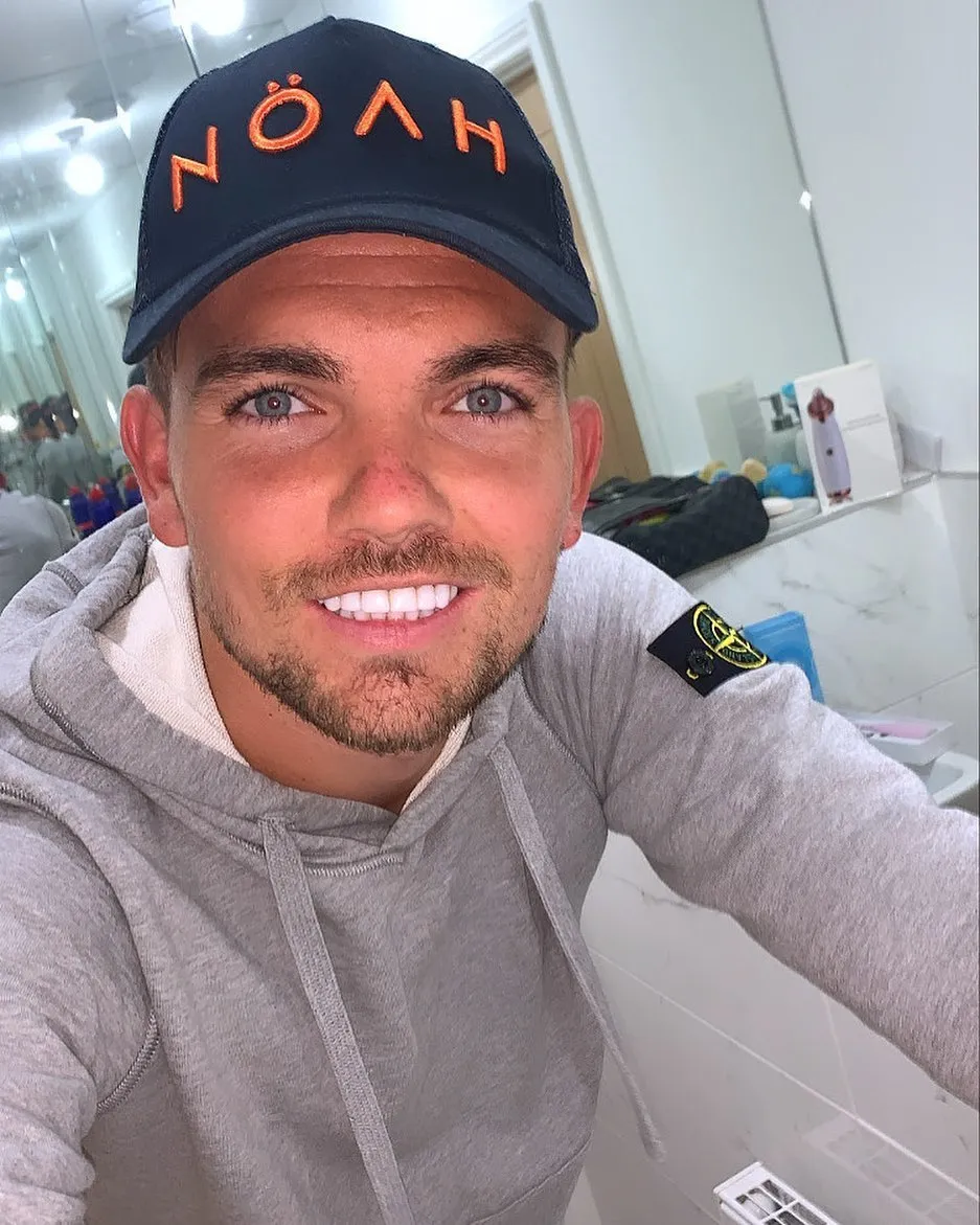 Sam Gowland smiling in a selfie, showing his bright, even white teeth