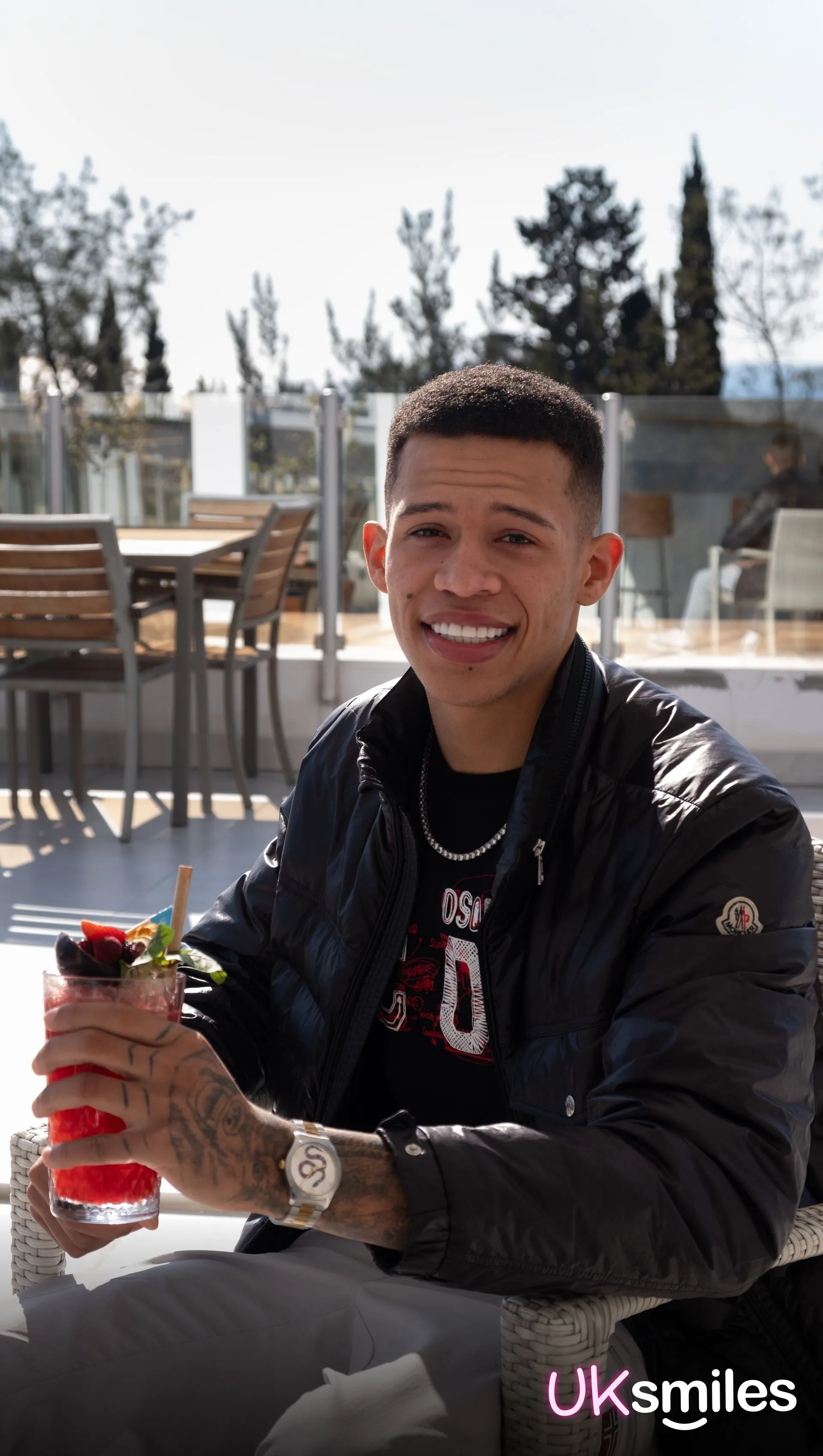 Young man with a drink on a terrace in Antalya after his treatment
